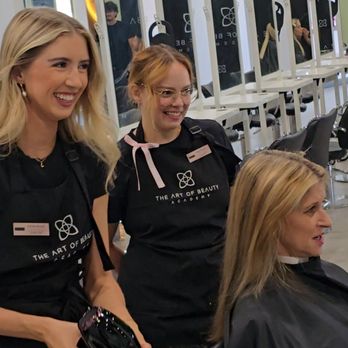 Instructors in The Art of Beauty Academy aprons working with a client in the salon studio at The Pavilions at Talking Stick in Scottsdale