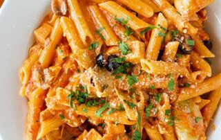 babbo-italian-eatery-pavilions-talking-stick-scottsdale A bowl of penne pasta in creamy tomato sauce with mushrooms, olives and artichokes at Babbo Italian Eatery in Scottsdale