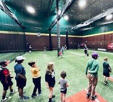 dbat-scottsdale-youth-baseball-camp-pavilions-talking-stick Young baseball players lined up for a coached hitting session in the indoor cages at D-BAT Scottsdale in The Pavilions at Talking Stick