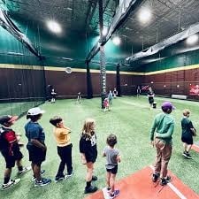 Young baseball players lined up for a coached hitting session in the indoor cages at D-BAT Scottsdale in The Pavilions at Talking Stick